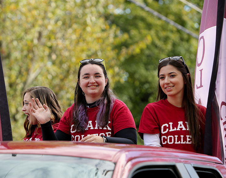 Students from Clark College wave in the Homecoming Parade
