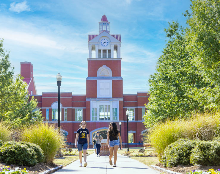 Students walk in front of science complex