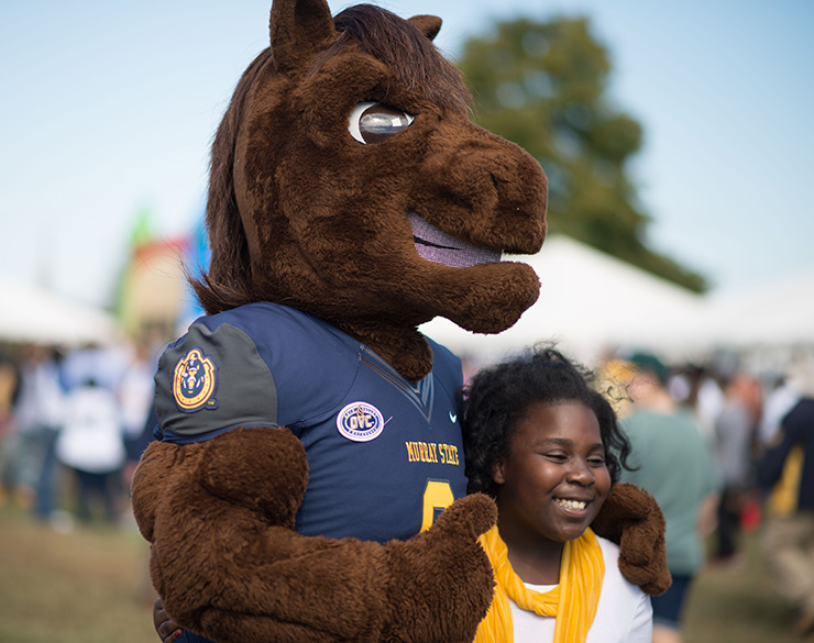 Young girl poses with Dunker at Homecoming