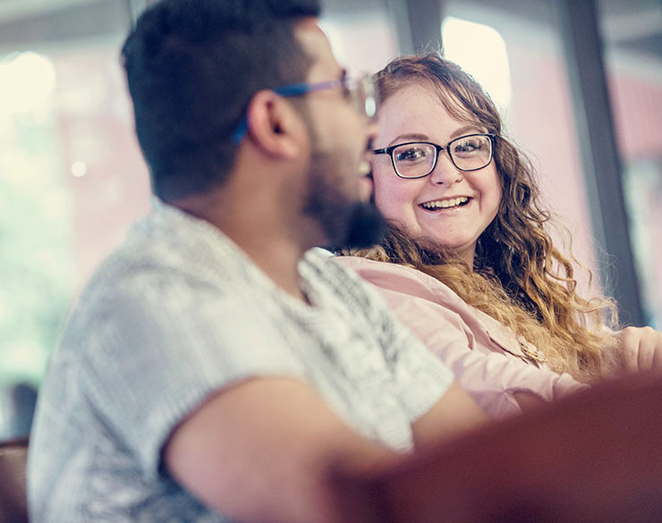 Two students smile in classroom