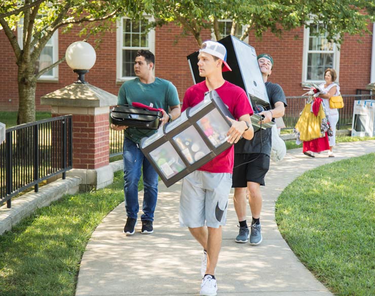 People carry items as they move into Clark College