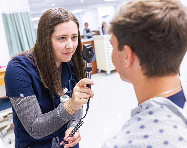 nursing student examines patient