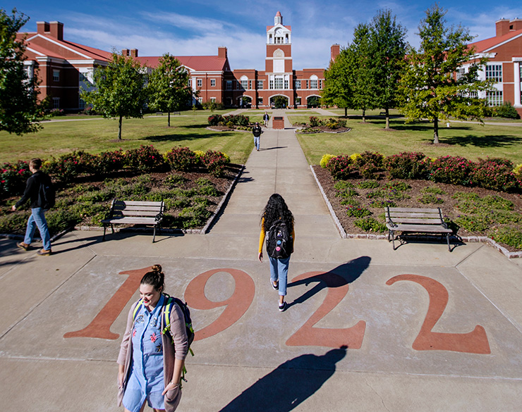 Students walk in front of science complex