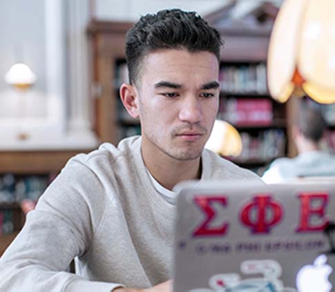 A student uses a laptop in Pogue