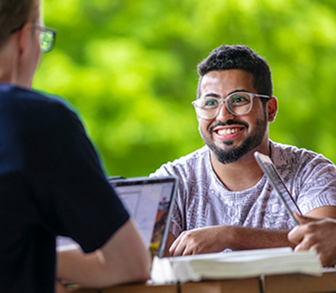 Student smiles at friends