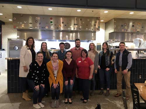 group poses at mellow mushroom