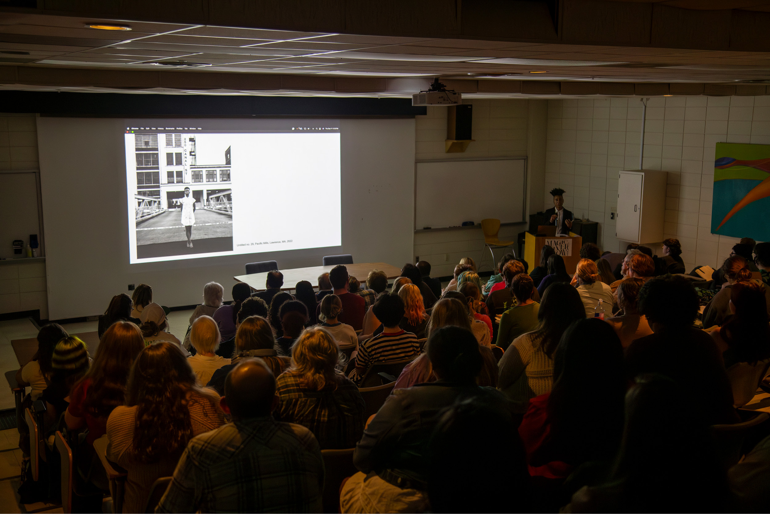 Overview of the art history lecture hall. A guest lecturer discusses his work in photography.