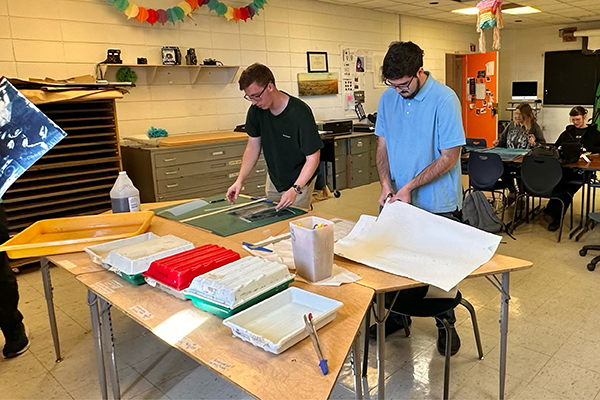 Photography students experiment with cyanotypes and other types of photography.