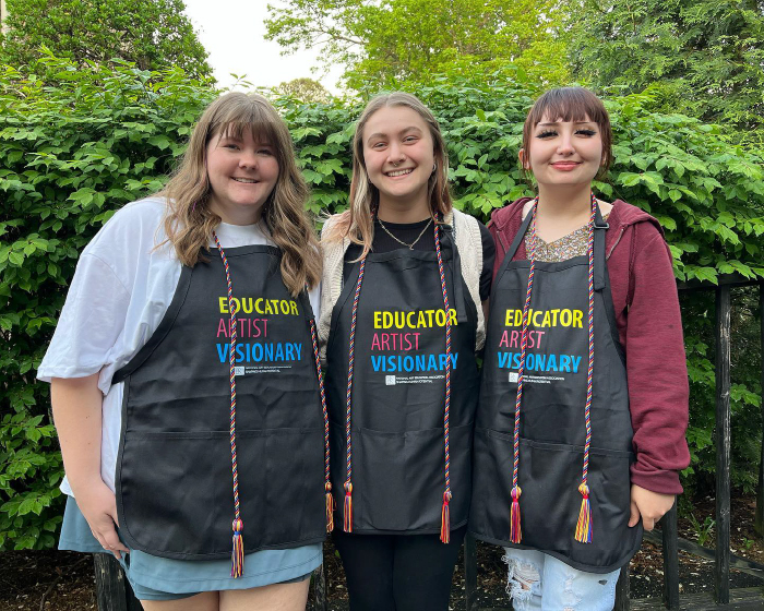 Graduating art education seniors pose with their honors cords.