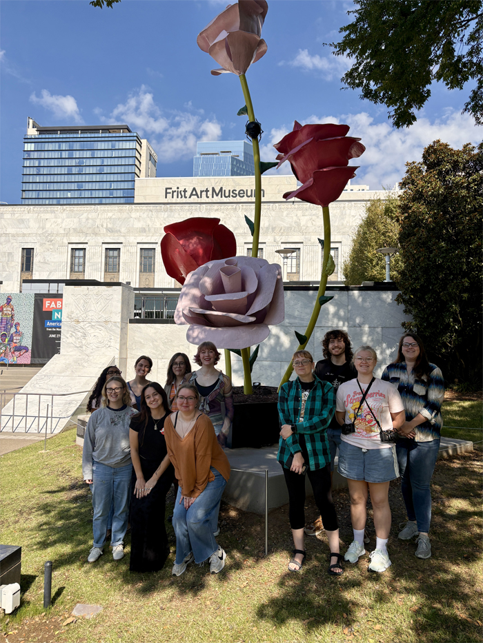 Art history students pose in front of a large rose sculpture outside the Frist Art Museum in Nashville, TN.