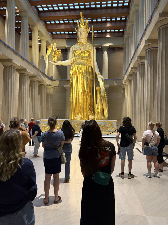 Art history students observe the large statue of Athena at the Parthenon in Nashville.
