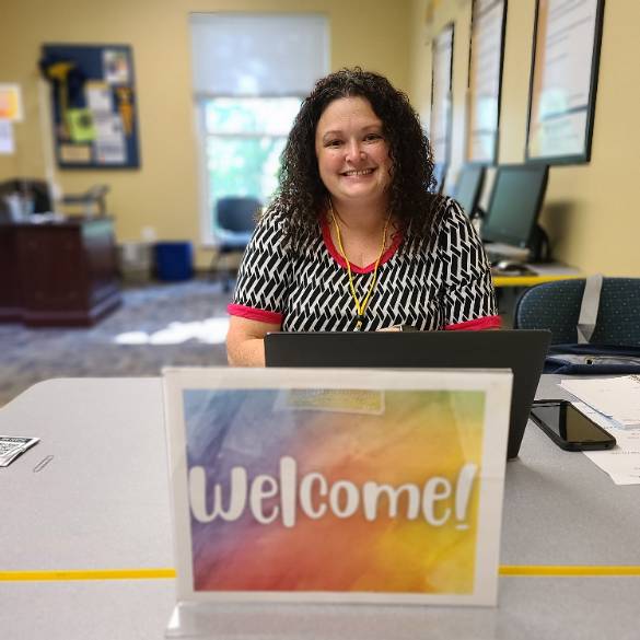 Welcome sign and staff member
