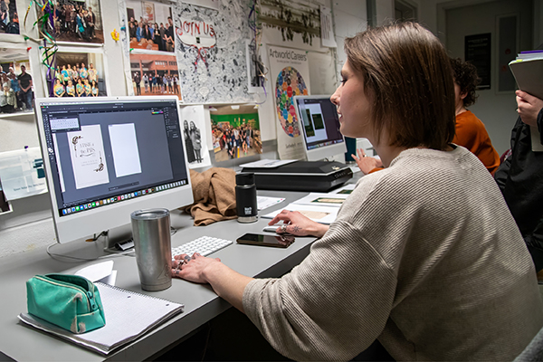 A graphic design student typesets a formal invitation. 