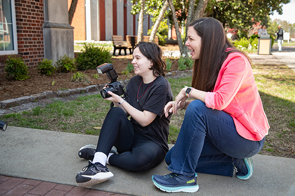 Professor Cintia Segovia Figueroa supervises a photography student.