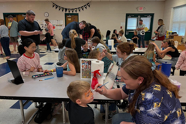 NAEA students host a face-painting event at Murray Elementary. 