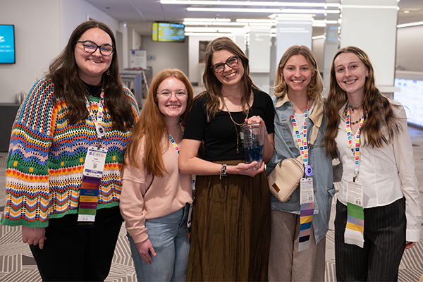 Dr. Rebecca Williams and four art education students pose for a photo at the 2026 National Art Educators Association conference. 