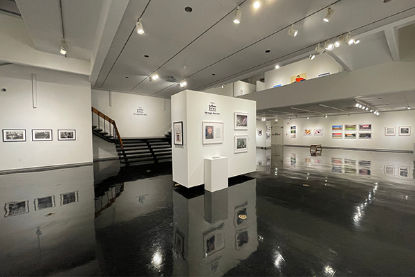Artworks are displayed along the walls of the Clara M. Eagle Gallery, with a portable wall and stand in the middle.