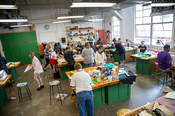 Overhead view of SAW students working on collages.