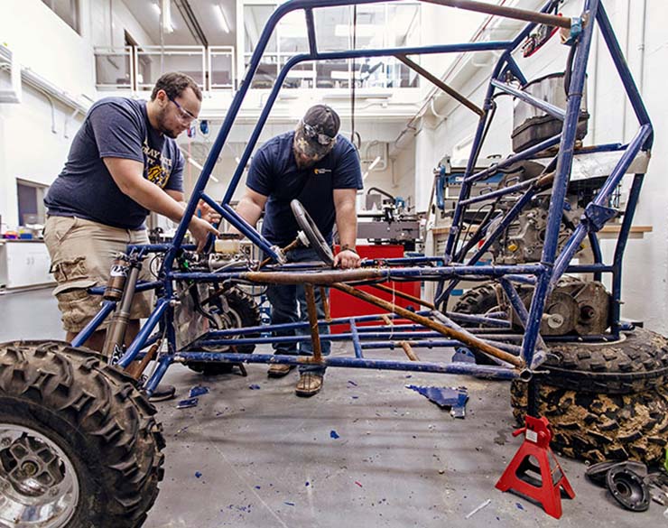 Students work on a buggy in the lab