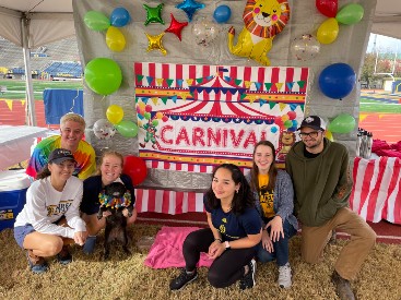 Honors students pose in front of their carnival-themed tent at Tent City.