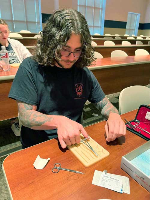 suturing during chapter meeting