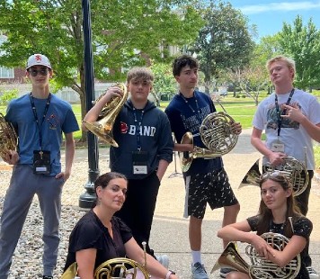 RIMA 2023 campers posing with their instructor and french horns