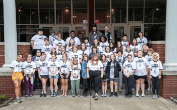 SAW students pose on the stairs