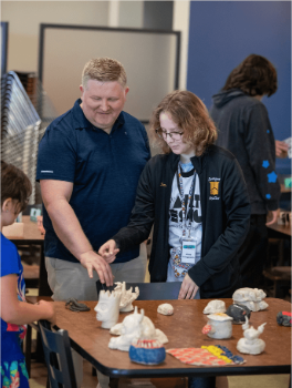SAW campers and families admiring ceramic pieces
