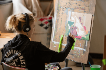 SAW camper working on a painting