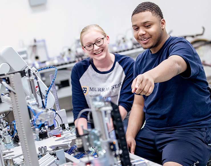 Two students work in the engineering department. Top university with a local college feel.