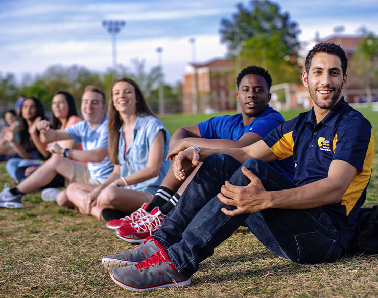 Students sit near the intramural fields