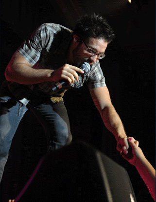 A singer reaches out to the audience during a concert at Lovett Auditorium.