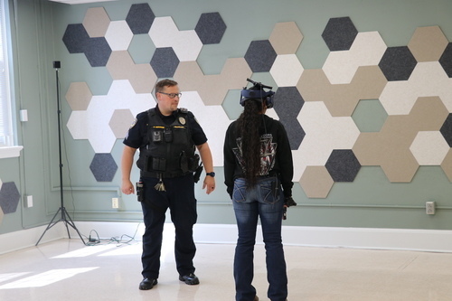 Sergeant Rick Mehlbauer guides a Murray State student through a VR training scenario