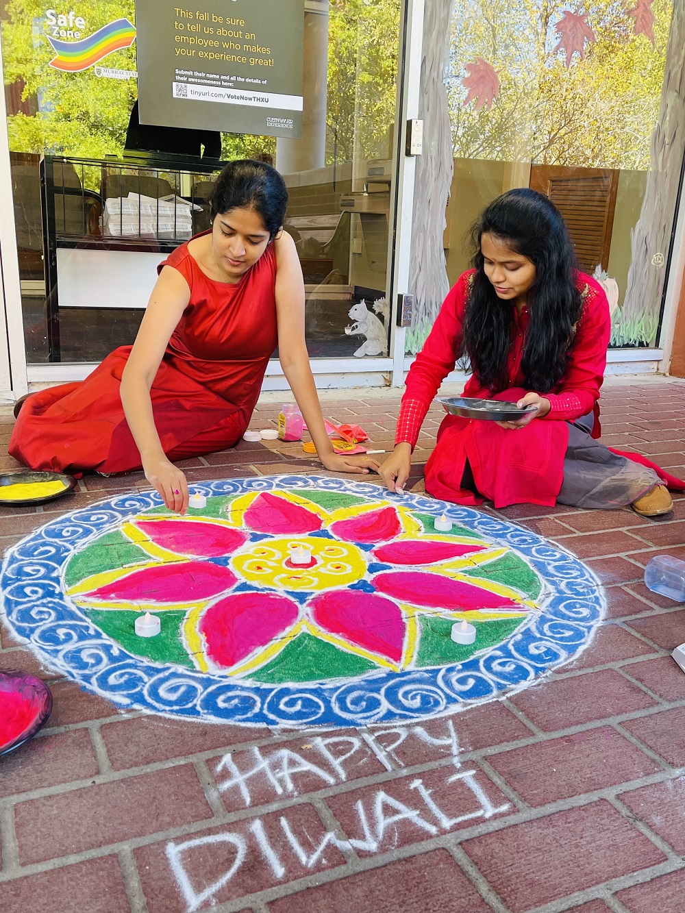 Members of the Indian Students Association create patterns on the floor called rangoli