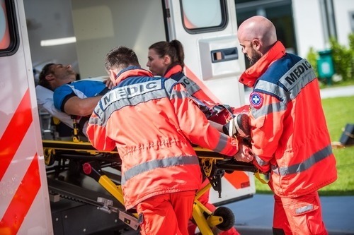 EMTs loading a patient in an ambulance
