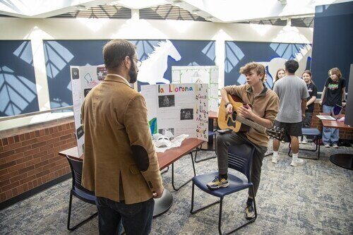 student with booth during Global Languages Showcase