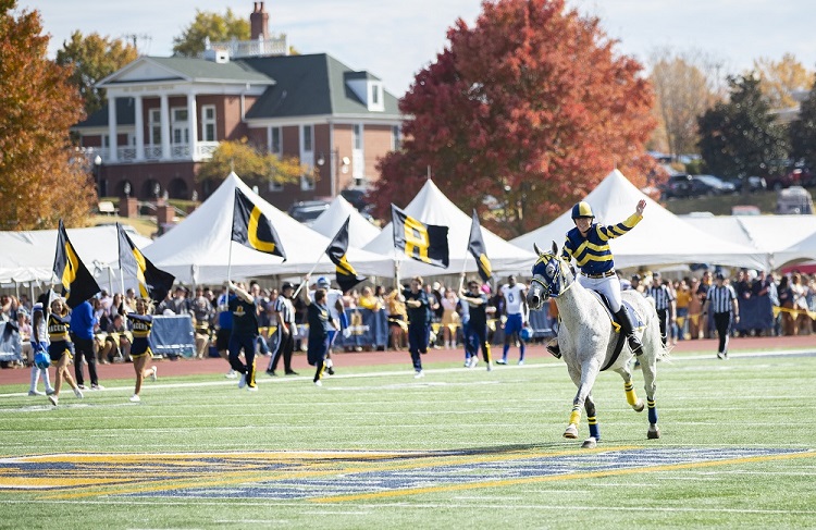 Racer One and the Murray State football team take the field. 