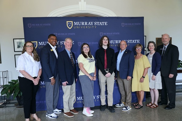 Coach Brady with scholarship recipients. 