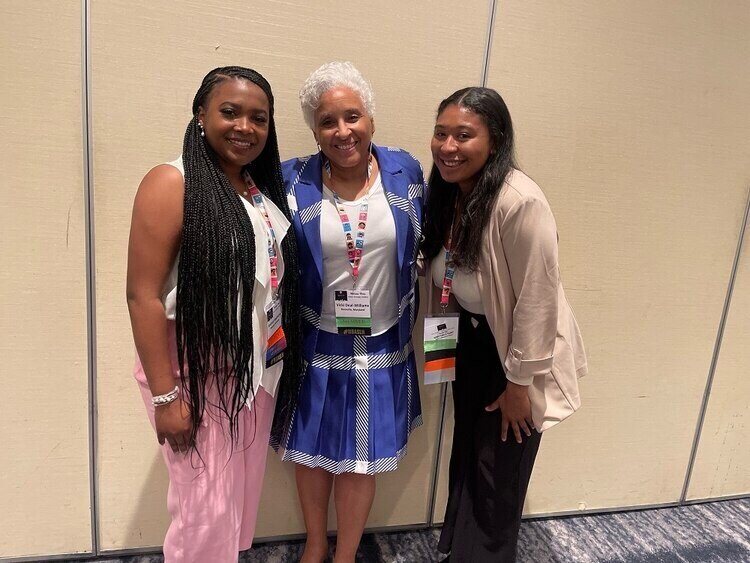Andriah Hawthorne, left and Yannah Marrow, right met American Speech-Language-Hearing Association Chief Executive Officer Vicki R. Deal-Williams, center