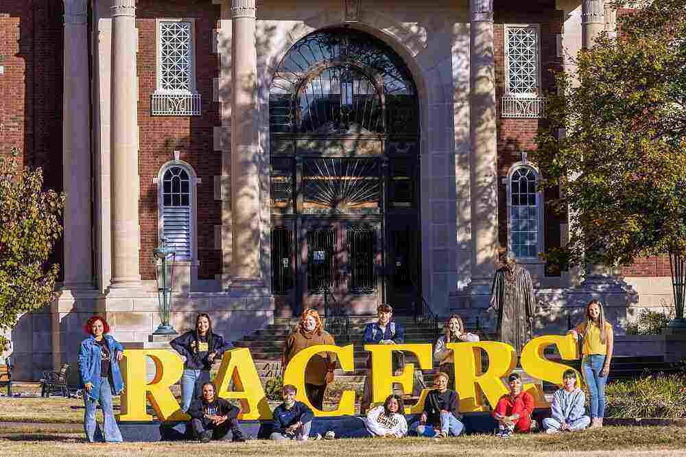 Students holding RACERS letters