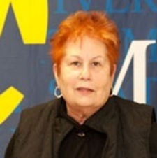 Dr. Peggy Pittman-Munke in a black shirt and silver earrings.