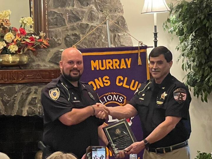 Officer Thomas Reynolds and Lions Club representative Ken Claud