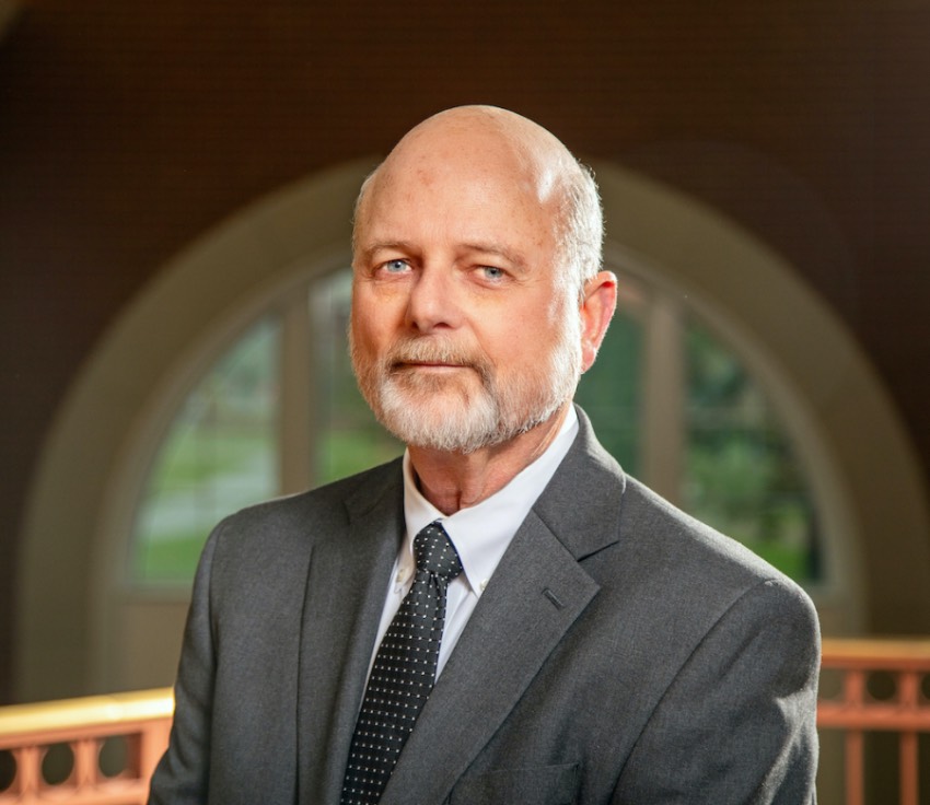 Dr. David Whaley in a gray suit and tie with a white shirt.
