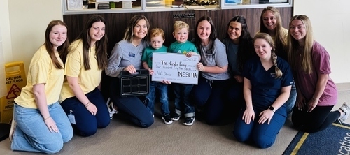 Students and faculty with the Crider family children