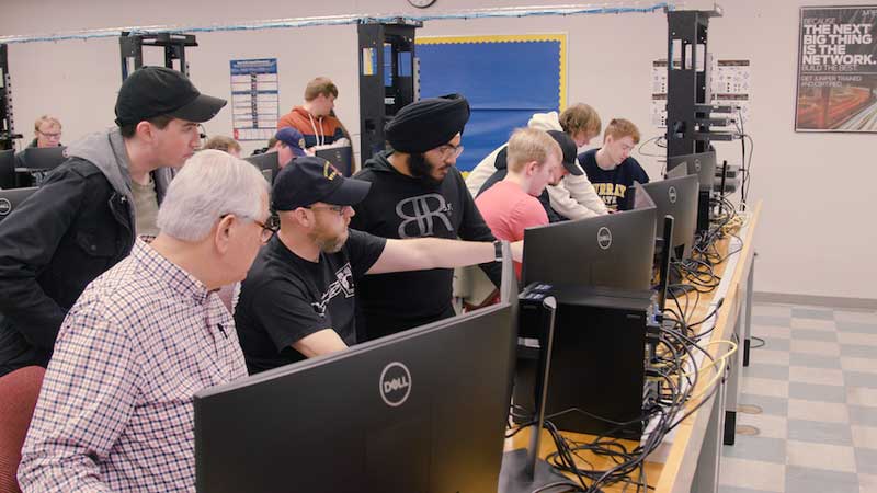 a group of students work together in a computer lab