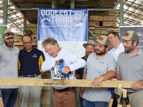 Senator Rand Paul performing the ceremonial board-cutting at the new HempWood location in Murray, KY