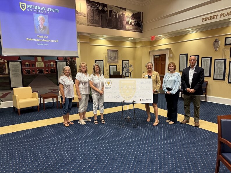 Beatrice Cornwell's sisters and administration pose with scholarship check