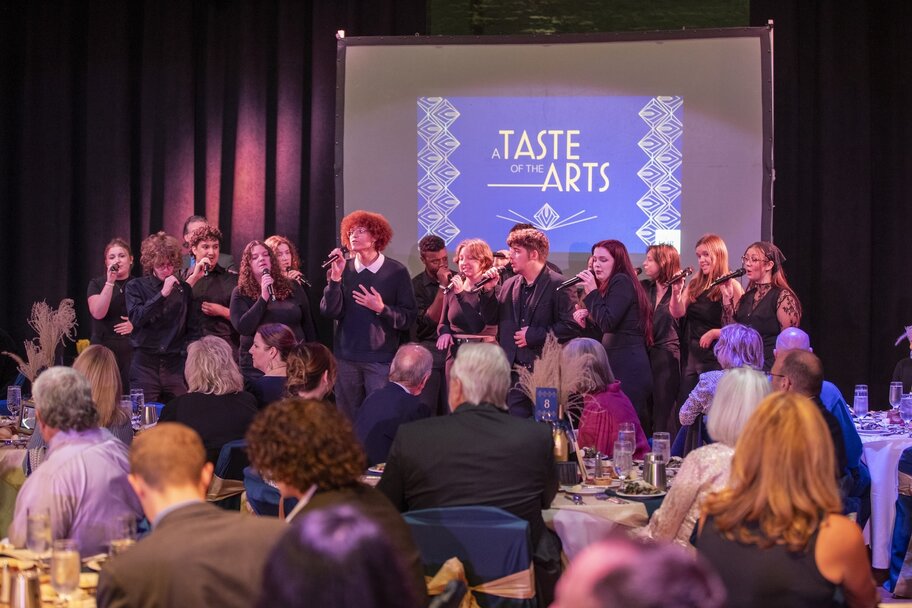Students singing to crowd of people in Taste of the Arts