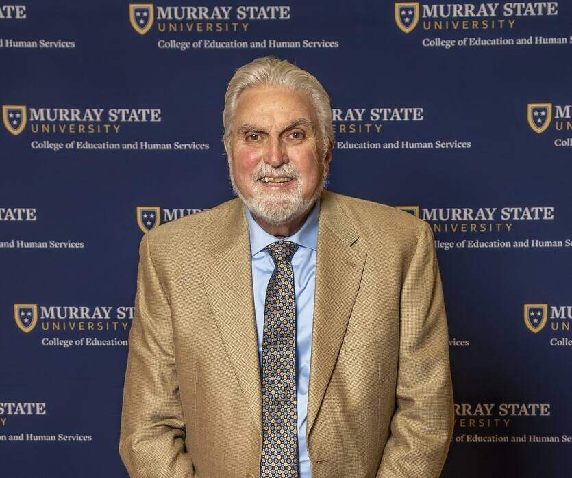 Tim McGinnis headshot photo with Murray State University backdrop