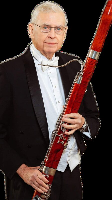 Dr. Edwin Lacey holding a bassoon